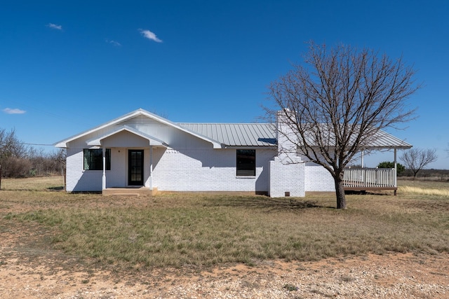 909 Crockett St, Santa Anna, TX 76878 - view of front of home featuring metal roof, a front yard, and brick siding