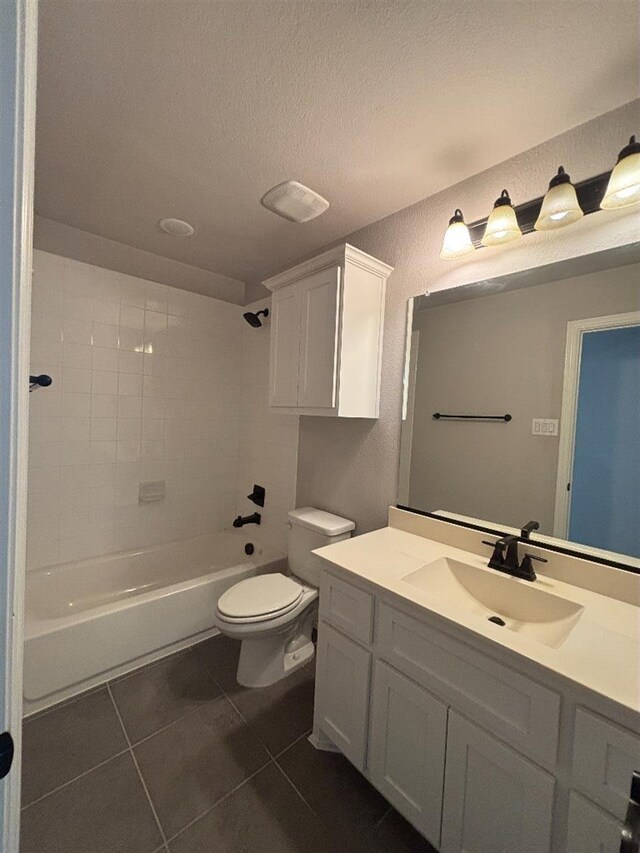 bathroom featuring vanity, tile patterned flooring, shower / tub combination, a textured ceiling, and toilet