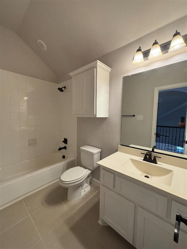 full bathroom featuring vanity, shower / tub combination, vaulted ceiling, toilet, and tile patterned floors