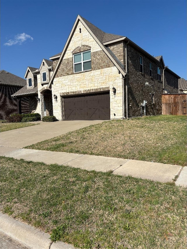 view of front facade featuring a front yard, stone siding, a garage, and concrete driveway