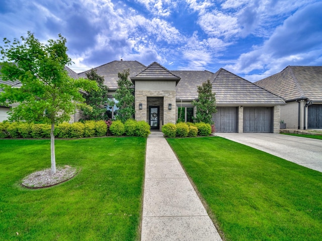 8505 Tierra Ct, Benbrook, TX 76126 - french provincial home featuring an attached garage, stone siding, a front lawn, and driveway