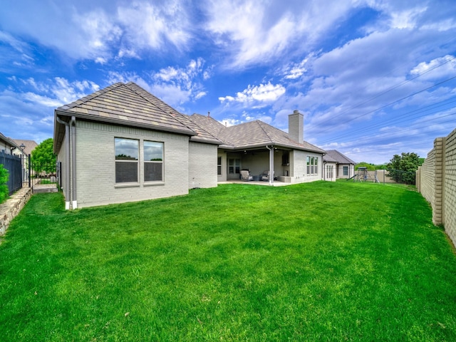 8505 Tierra Ct, Benbrook, TX 76126 - rear view of house with a fenced backyard, brick siding, a yard, and a patio