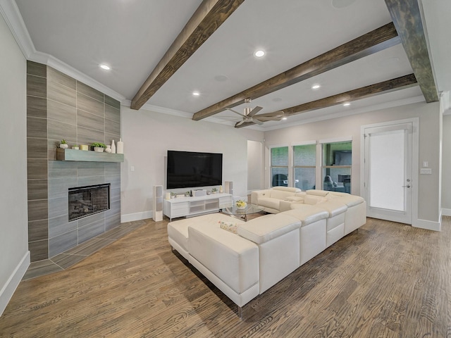 8505 Tierra Ct, Benbrook, TX 76126 - living room with wood finished floors, a tiled fireplace, a ceiling fan, and baseboards