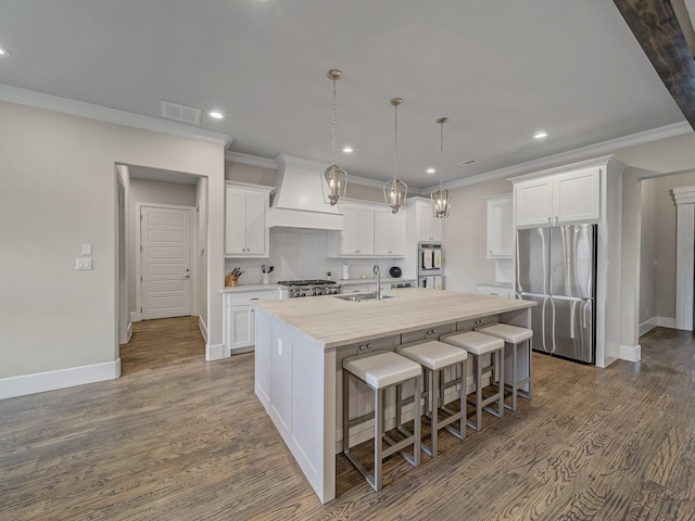 8505 Tierra Ct, Benbrook, TX 76126 - kitchen with custom exhaust hood, a sink, freestanding refrigerator, ornamental molding, and recessed lighting
