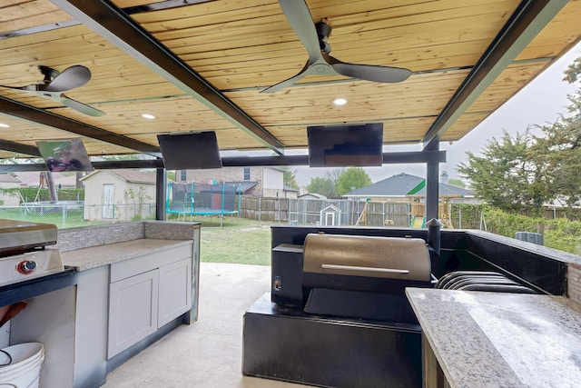 510 Springtime Dr, Cedar Hill, TX 75104 - view of patio / terrace with a trampoline, an outdoor kitchen, and a ceiling fan