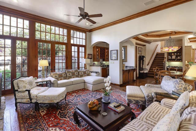 3636 Amherst Ave, University Park, TX 75225 - living room featuring ceiling fan, crown molding, wood finished floors, arched walkways, and stairway