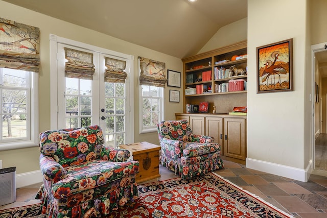 3636 Amherst Ave, University Park, TX 75225 - living area featuring plenty of natural light, vaulted ceiling, baseboards, and stone finish floor