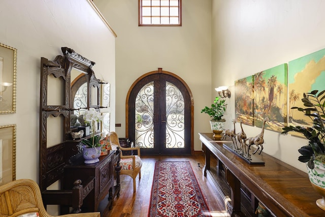 3636 Amherst Ave, University Park, TX 75225 - entryway with french doors, a towering ceiling, arched walkways, and hardwood / wood-style flooring