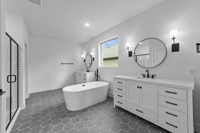 248 Diamond Dl, Lavon, TX 75166 - full bathroom featuring a shower stall, two vanities, a freestanding bath, recessed lighting, and tile patterned flooring
