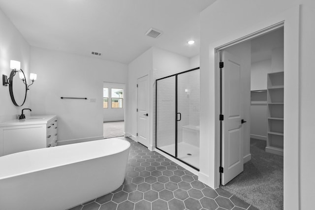 248 Diamond Dl, Lavon, TX 75166 - full bath with a stall shower, a freestanding bath, vanity, tile patterned flooring, and a spacious closet
