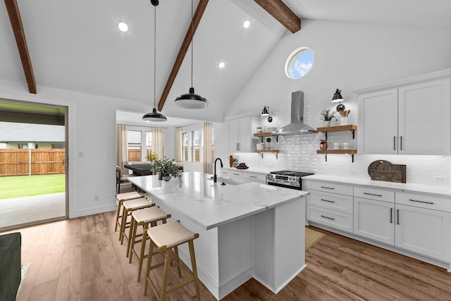 248 Diamond Dl, Lavon, TX 75166 - kitchen featuring island exhaust hood, beamed ceiling, stainless steel gas range oven, backsplash, and a center island with sink