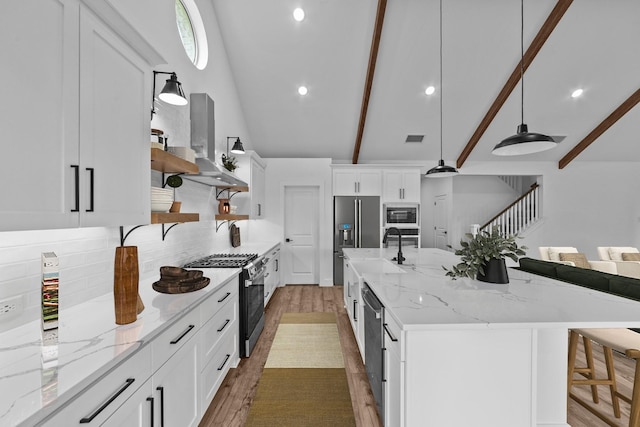 248 Diamond Dl, Lavon, TX 75166 - kitchen featuring appliances with stainless steel finishes, open shelves, wall chimney range hood, wood finished floors, and decorative backsplash