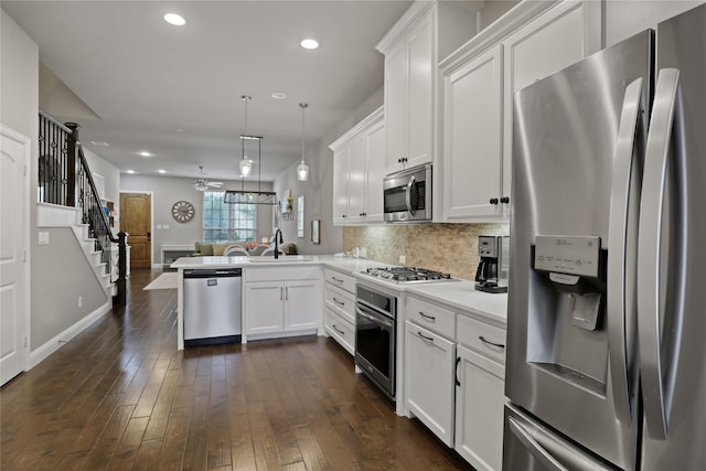 kitchen featuring backsplash, light countertops, white cabinetry, and stainless steel appliances