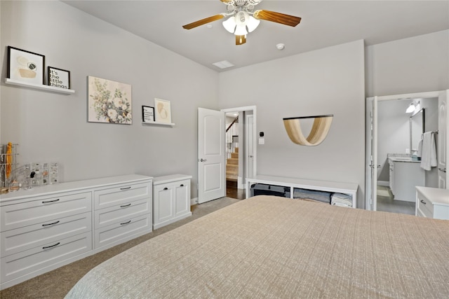 bedroom featuring carpet floors, a ceiling fan, and connected bathroom