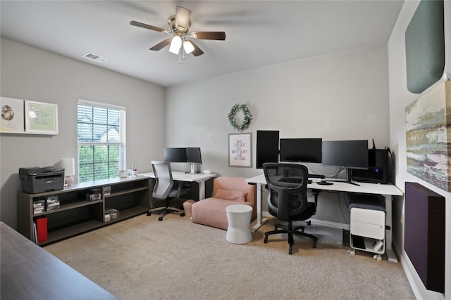 carpeted office space featuring visible vents and ceiling fan