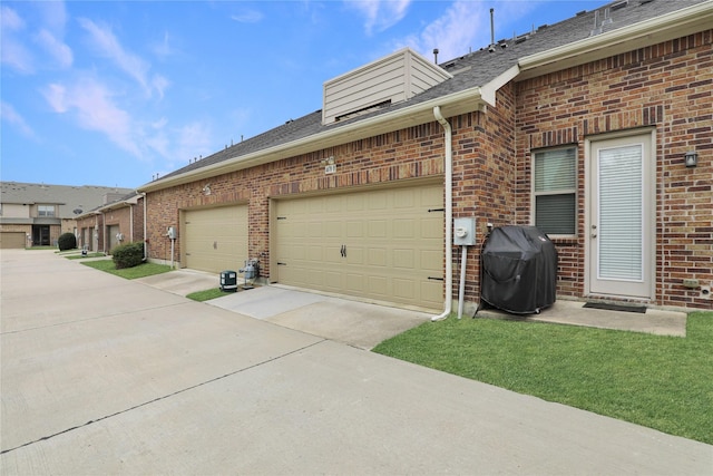 view of home's exterior with a shingled roof, driveway, brick siding, and a garage