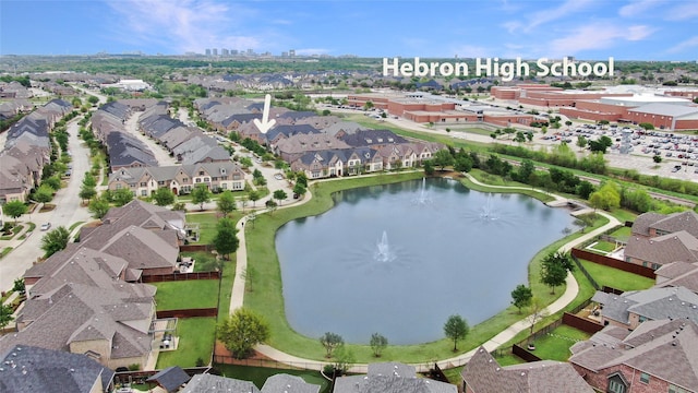 drone / aerial view featuring a water view and a residential view