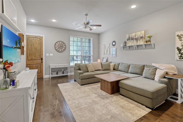 living area featuring baseboards, dark wood-style flooring, a ceiling fan, and recessed lighting