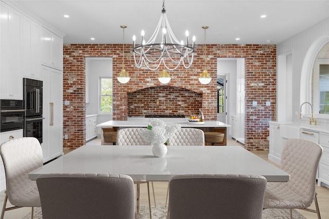 401 Lution Dr, Weatherford, TX 76087 - dining space with brick wall, a chandelier, and recessed lighting