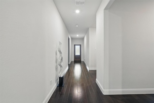 corridor featuring recessed lighting, visible vents, baseboards, and dark wood-style floors