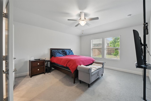 bedroom with baseboards, a ceiling fan, and light colored carpet