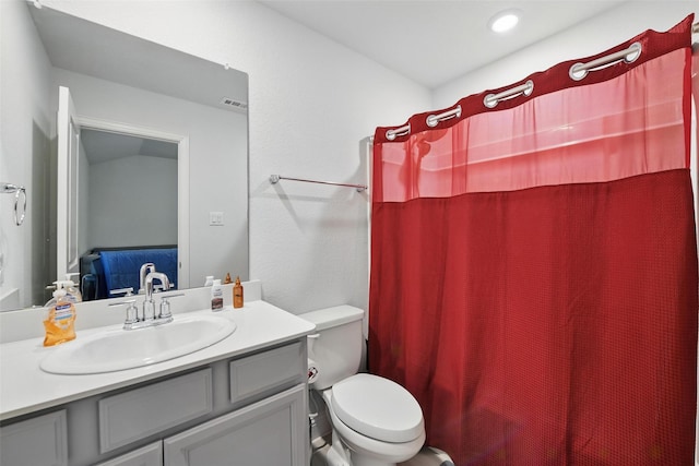 bathroom with visible vents, toilet, curtained shower, and vanity