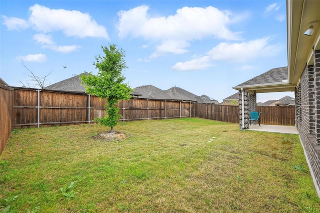 view of yard featuring a patio and a fenced backyard