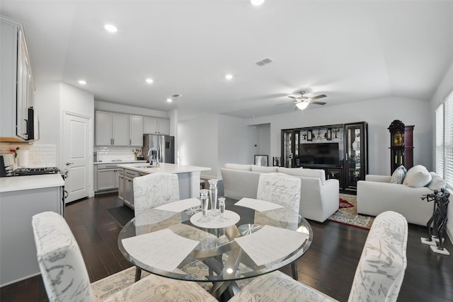 dining space with visible vents, dark wood-style flooring, ceiling fan, recessed lighting, and vaulted ceiling