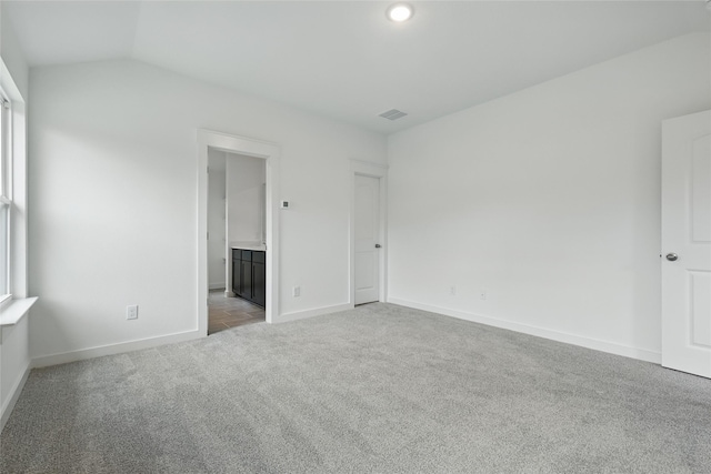 1321 Cider St, Forney, TX 75126 - unfurnished bedroom with visible vents, vaulted ceiling, baseboards, carpet, and ensuite bath