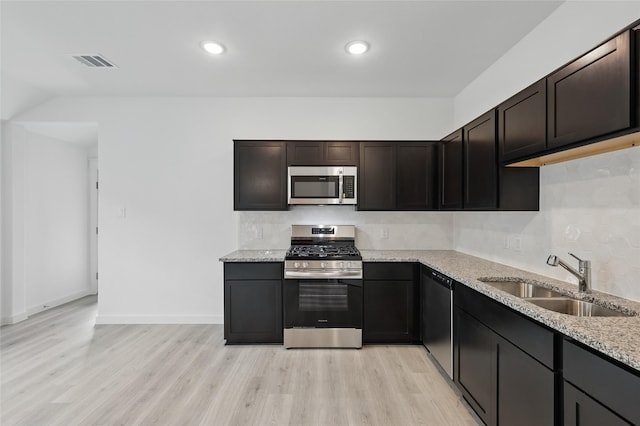 1321 Cider St, Forney, TX 75126 - kitchen with visible vents, a sink, decorative backsplash, and stainless steel appliances