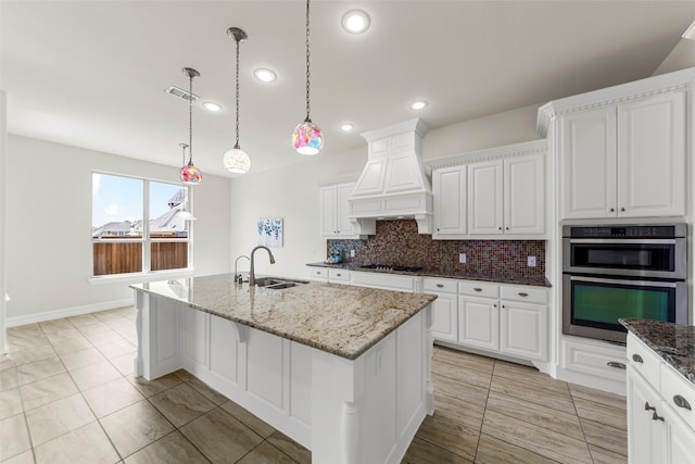 971 Abbott Ln, Allen, TX 75013 - kitchen featuring a sink, black gas cooktop, custom exhaust hood, backsplash, and light stone counters
