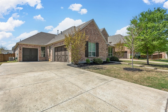 971 Abbott Ln, Allen, TX 75013 - view of front of property featuring brick siding, a garage, a shingled roof, central AC unit, and driveway