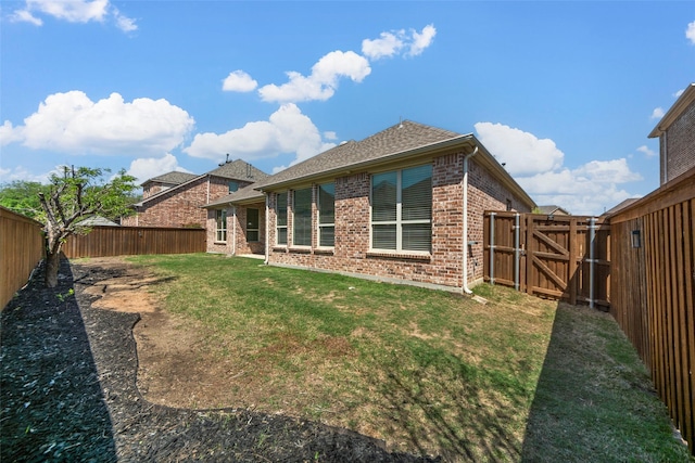 971 Abbott Ln, Allen, TX 75013 - rear view of house with brick siding, roof with shingles, and a gate