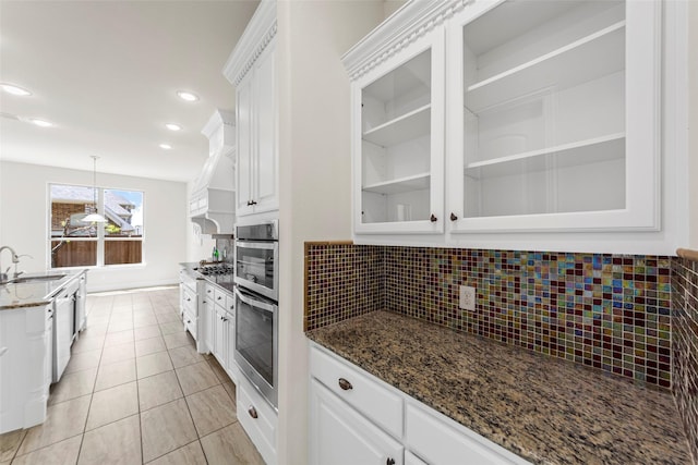971 Abbott Ln, Allen, TX 75013 - kitchen with white cabinets, backsplash, glass insert cabinets, dark stone counters, and decorative light fixtures