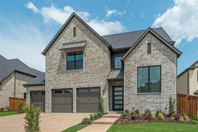 view of front facade featuring brick siding, fence, driveway, and a standing seam roof