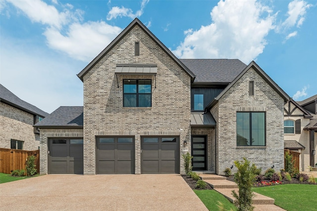 view of front of house featuring a standing seam roof, driveway, brick siding, fence, and a shingled roof