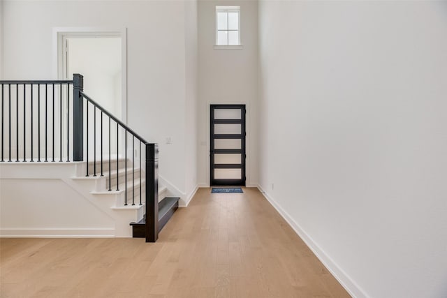 foyer entrance featuring light wood-type flooring and baseboards