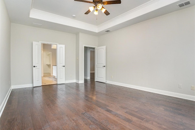 9108 Blue Water Dr, Plano, TX 75025 - unfurnished bedroom with a tray ceiling, baseboards, visible vents, and dark wood finished floors