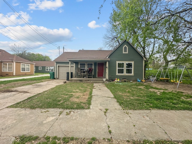 706 N Commerce St, Gainesville, TX 76240 - view of front of house with an attached garage, covered porch, a front yard, and concrete driveway