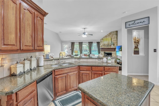 kitchen with dishwasher, brown cabinets, a sink, and ceiling fan