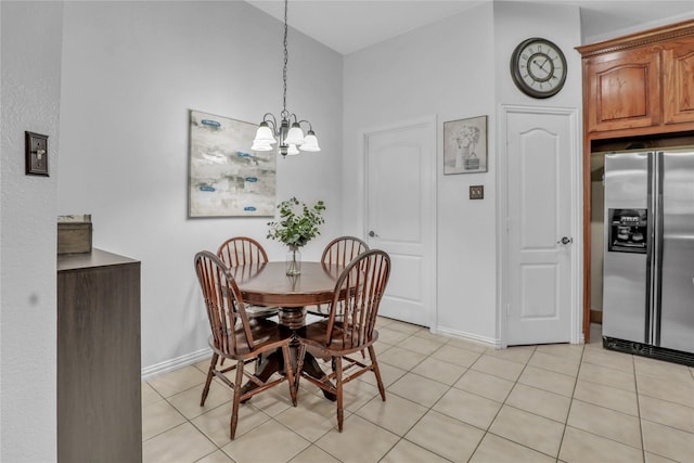 dining space with light tile patterned floors, a notable chandelier, and baseboards