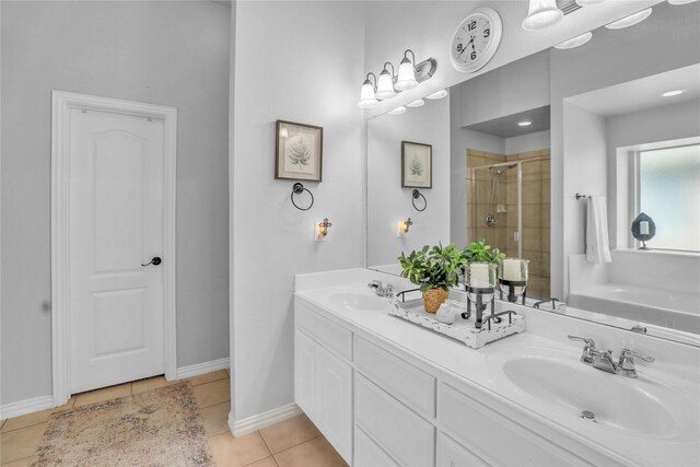 bathroom with a shower stall, tile patterned floors, baseboards, and a sink