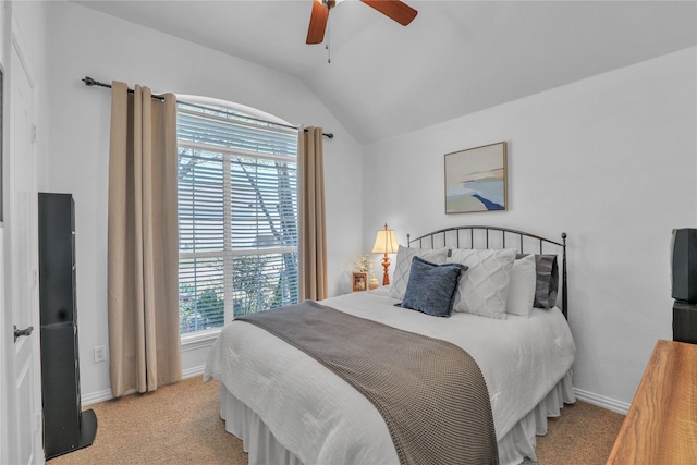 bedroom with light colored carpet, multiple windows, baseboards, and lofted ceiling