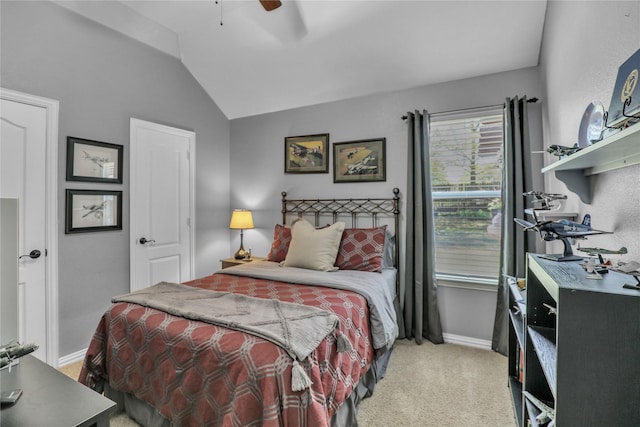 bedroom with light colored carpet, baseboards, vaulted ceiling, and ceiling fan