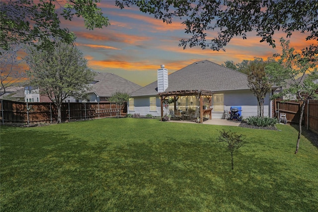 back of property featuring a chimney, a pergola, a patio area, a fenced backyard, and a yard