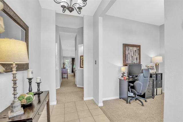 carpeted office space with a chandelier, tile patterned floors, and baseboards