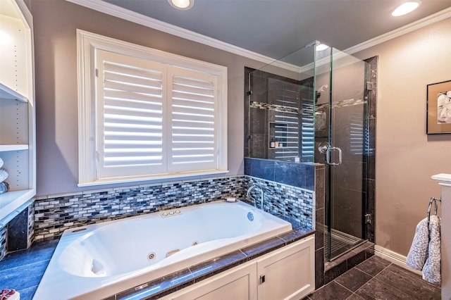 full bathroom with a stall shower, a tub with jets, ornamental molding, and baseboards