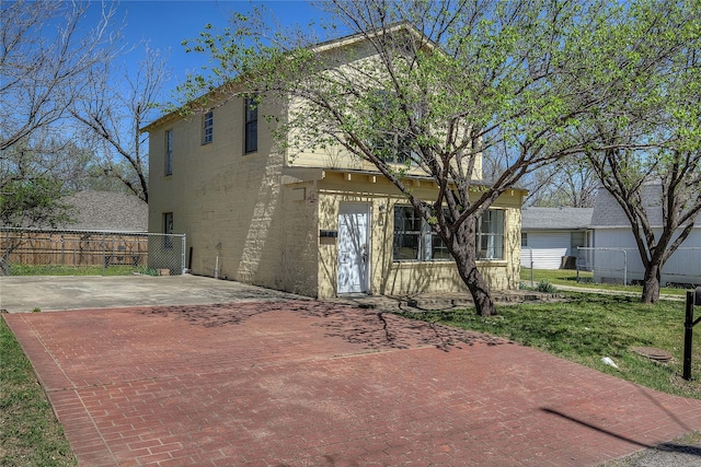 rear view of house featuring fence