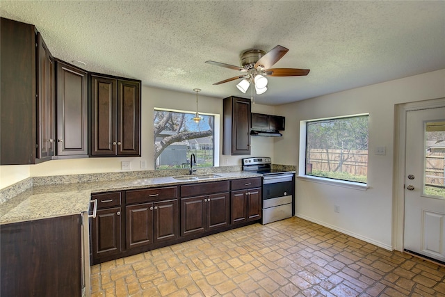 kitchen featuring ceiling fan, stainless steel electric stove, dark brown cabinets, a sink, and baseboards