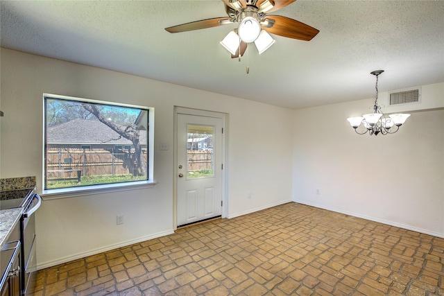 empty room featuring brick floor, visible vents, baseboards, and ceiling fan with notable chandelier